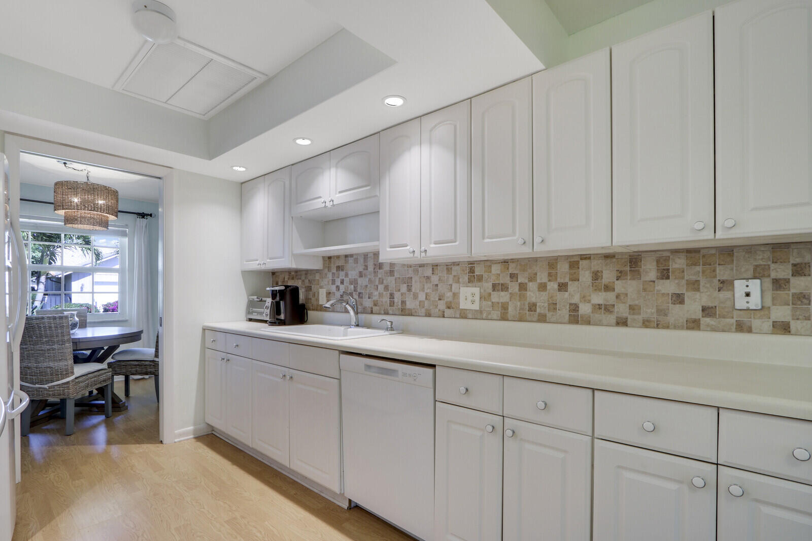 8574 Southeast Seagrape Way Hobe Sound, FL 33455 - Photo 16 of 38 a kitchen with white cabinets