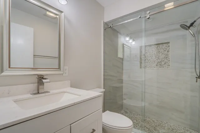 a bathroom with a sink toilet and shower