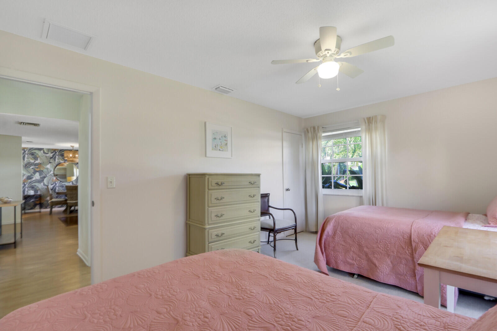 8574 Southeast Seagrape Way Hobe Sound, FL 33455 - Photo 23 of 38 a bedroom with a bed and a chandelier