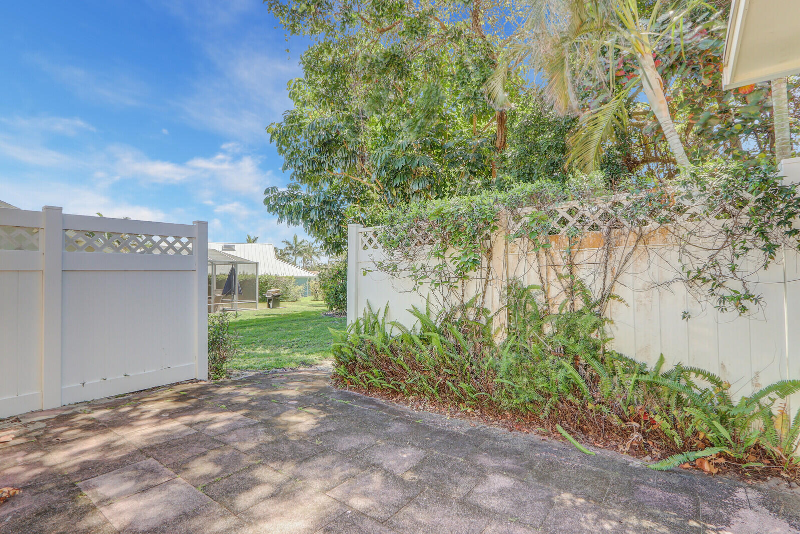 8574 Southeast Seagrape Way Hobe Sound, FL 33455 - Photo 33 of 38 a view of a yard with plants and trees