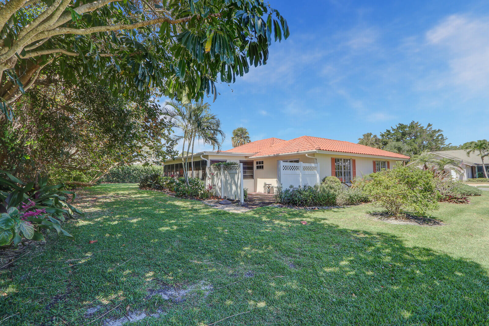 8574 Southeast Seagrape Way Hobe Sound, FL 33455 - Photo 35 of 38 a view of a house with a yard