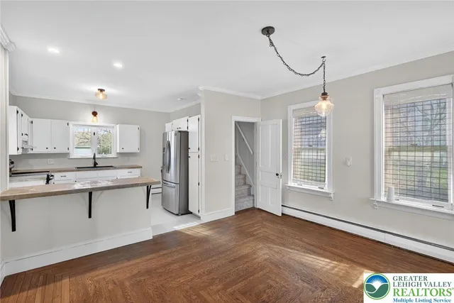 a kitchen with a refrigerator a sink dishwasher and wooden cabinets