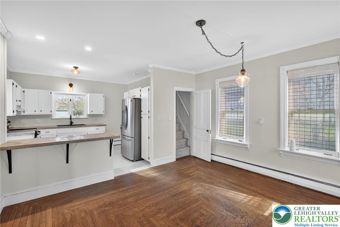 49 East Cherry Road Quakertown, PA 18951 - Photo 25 of 54 a kitchen with stainless steel appliances granite countertop a stove a sink dishwasher a refrigerator and white cabinets with wooden floor