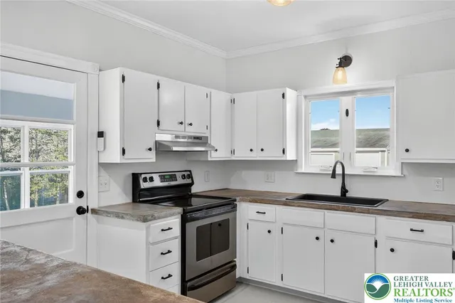 a kitchen with stainless steel appliances a refrigerator and a refrigerator
