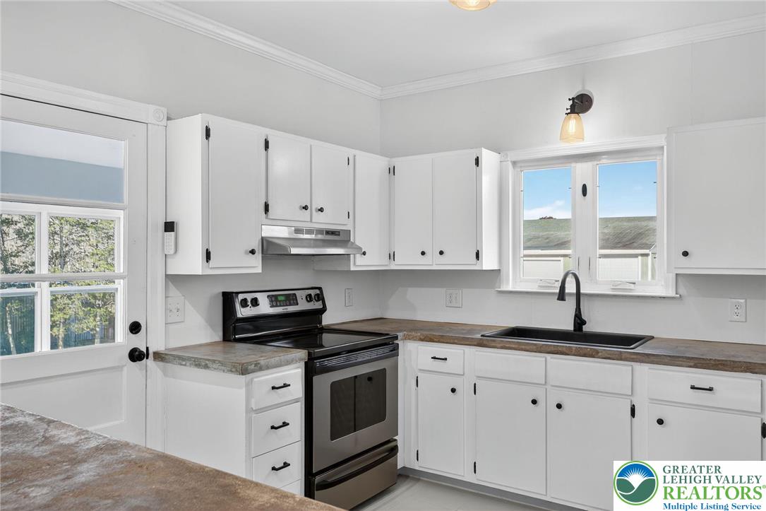 49 East Cherry Road Quakertown, PA 18951 - Photo 28 of 54 a kitchen with granite countertop white cabinets white appliances and a sink
