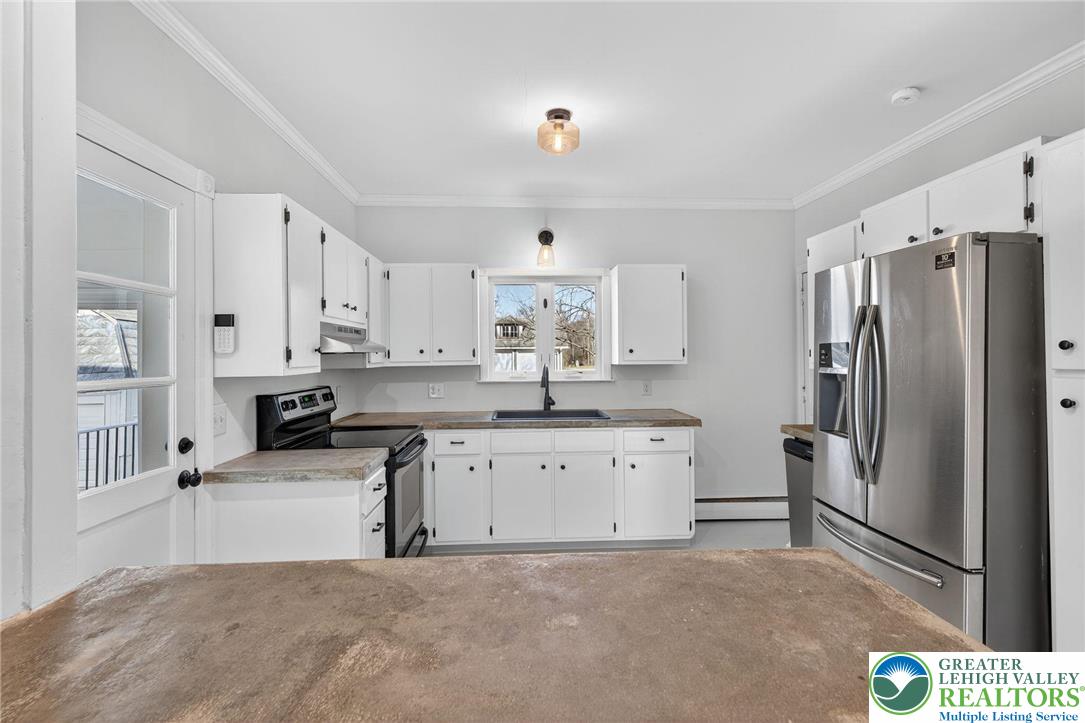 49 East Cherry Road Quakertown, PA 18951 - Photo 29 of 54 a kitchen with stainless steel appliances a refrigerator sink and white cabinets