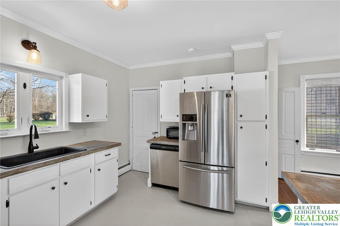 49 East Cherry Road Quakertown, PA 18951 - Photo 31 of 54 a kitchen with stainless steel appliances a refrigerator sink and cabinets