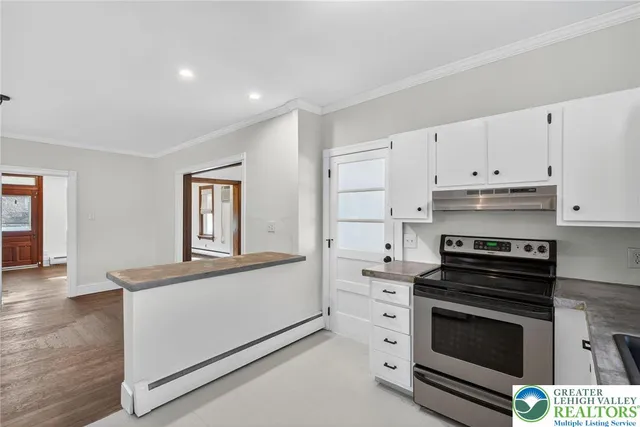 a view of a hallway with a glass door and shower