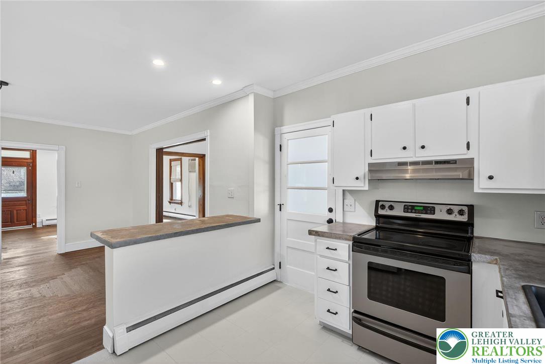 49 East Cherry Road Quakertown, PA 18951 - Photo 32 of 54 a kitchen with cabinets appliances and a wooden floor