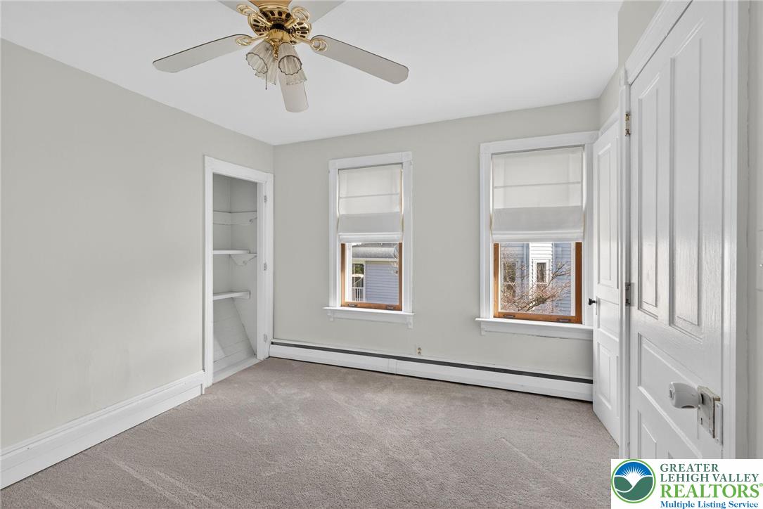 49 East Cherry Road Quakertown, PA 18951 - Photo 39 of 54 an empty room with windows and ceiling fan
