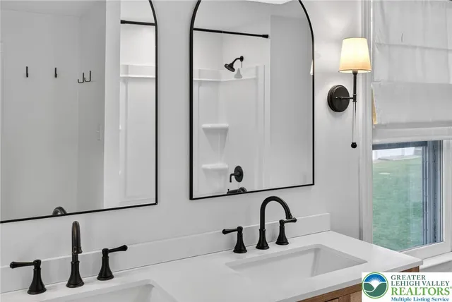 a bathroom with a sink vanity and mirror