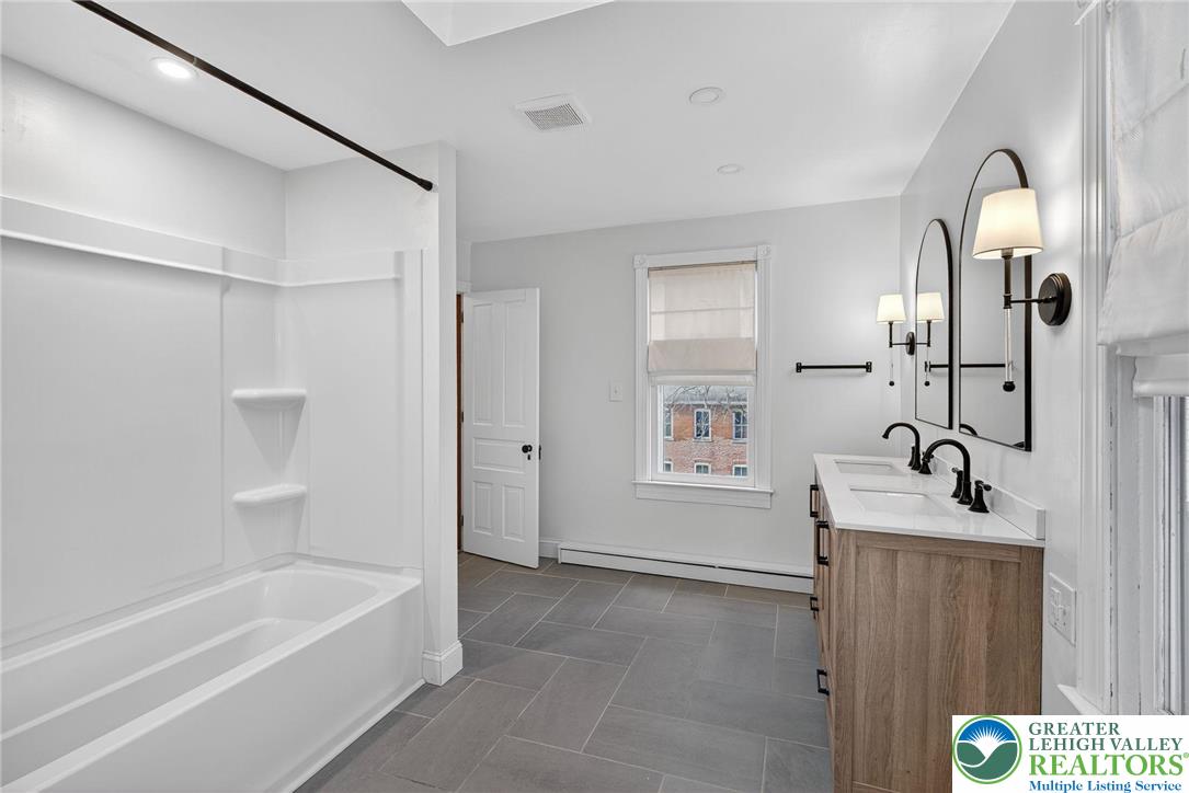 49 East Cherry Road Quakertown, PA 18951 - Photo 42 of 54 a bathroom with a tub sink and mirror