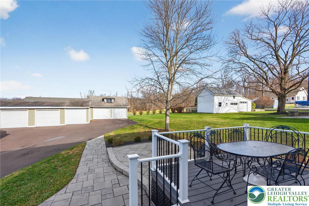49 East Cherry Road Quakertown, PA 18951 - Photo 9 of 54 a view of a deck with table and chairs potted plants and large tree