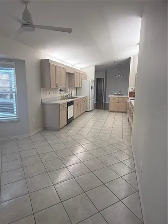 a kitchen with stainless steel appliances a sink window and cabinets