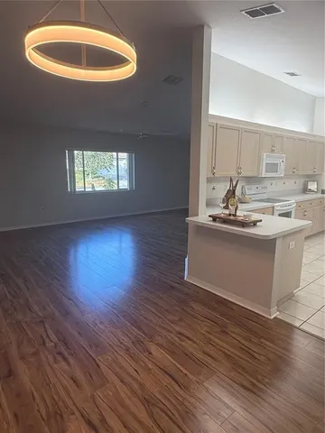 an empty room with windows and glass door