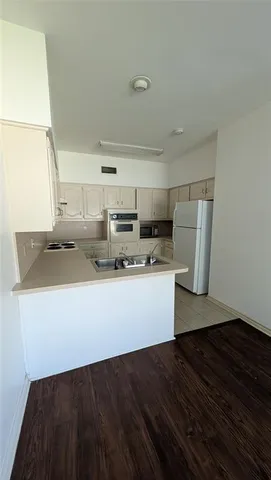a view of kitchen with stainless steel appliances granite countertop a stove a sink and a refrigerator
