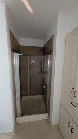 a bathroom with a shower and a sink