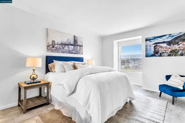 a bedroom with a bed and a lamp on table