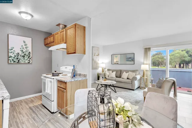 a living room with furniture appliances and a large window