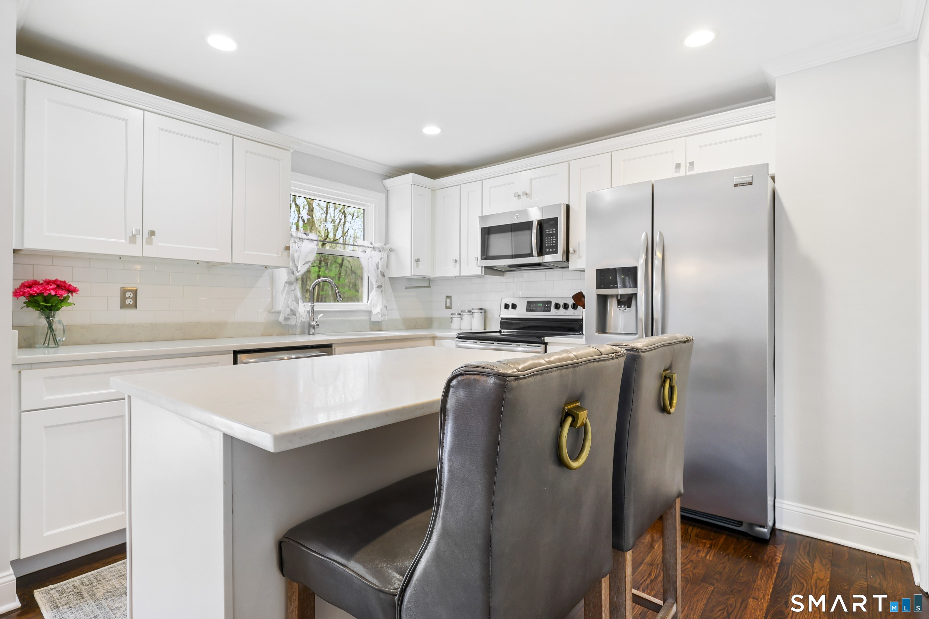 100 Flat Rock Drive Ridgefield, CT 06877 - Photo 13 of 40 a kitchen with stainless steel appliances a refrigerator stove microwave and sink