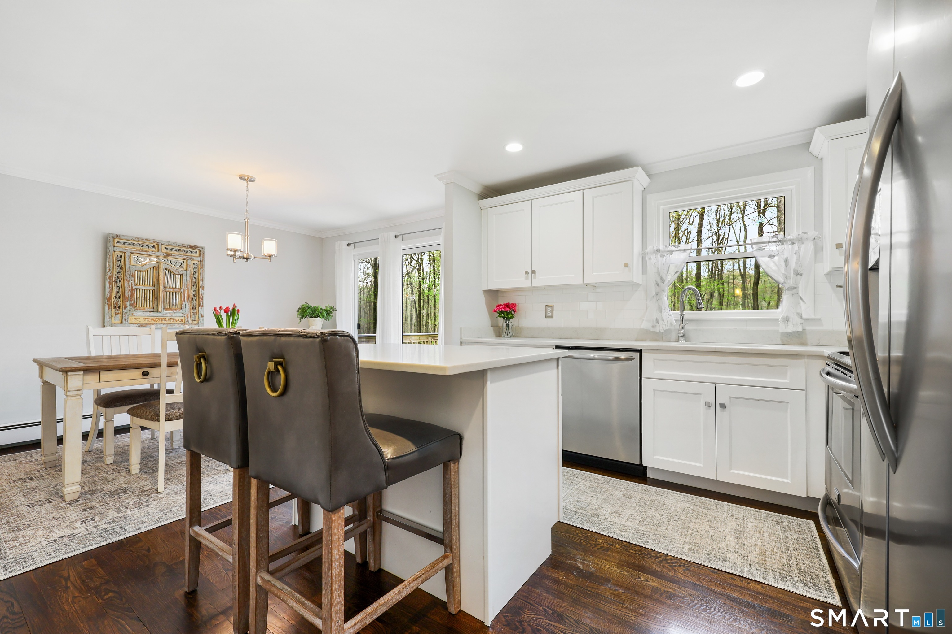 100 Flat Rock Drive Ridgefield, CT 06877 - Photo 14 of 40 a kitchen with a dining table cabinets appliances and wooden floor