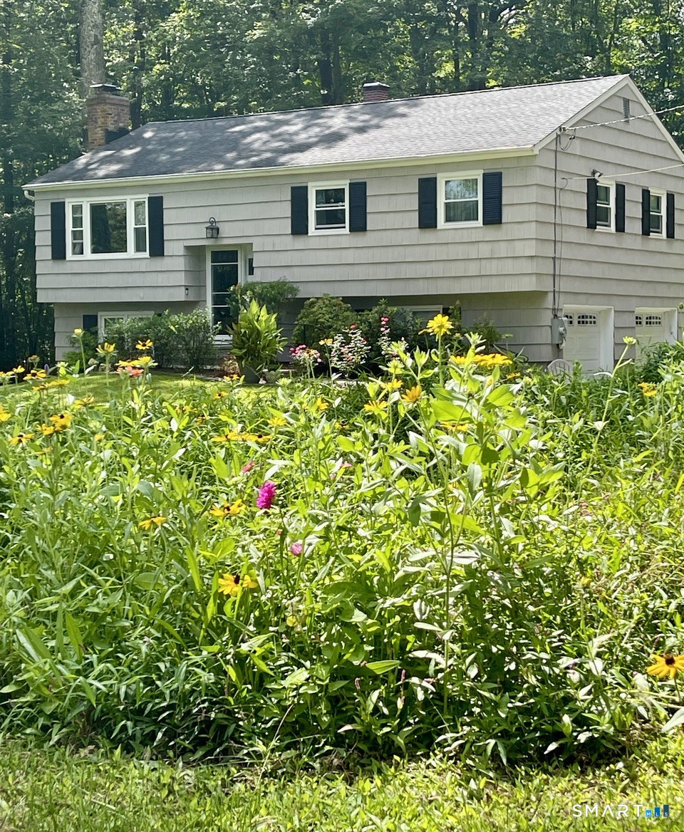 100 Flat Rock Drive Ridgefield, CT 06877 - Photo 2 of 40 a front view of a house with a yard