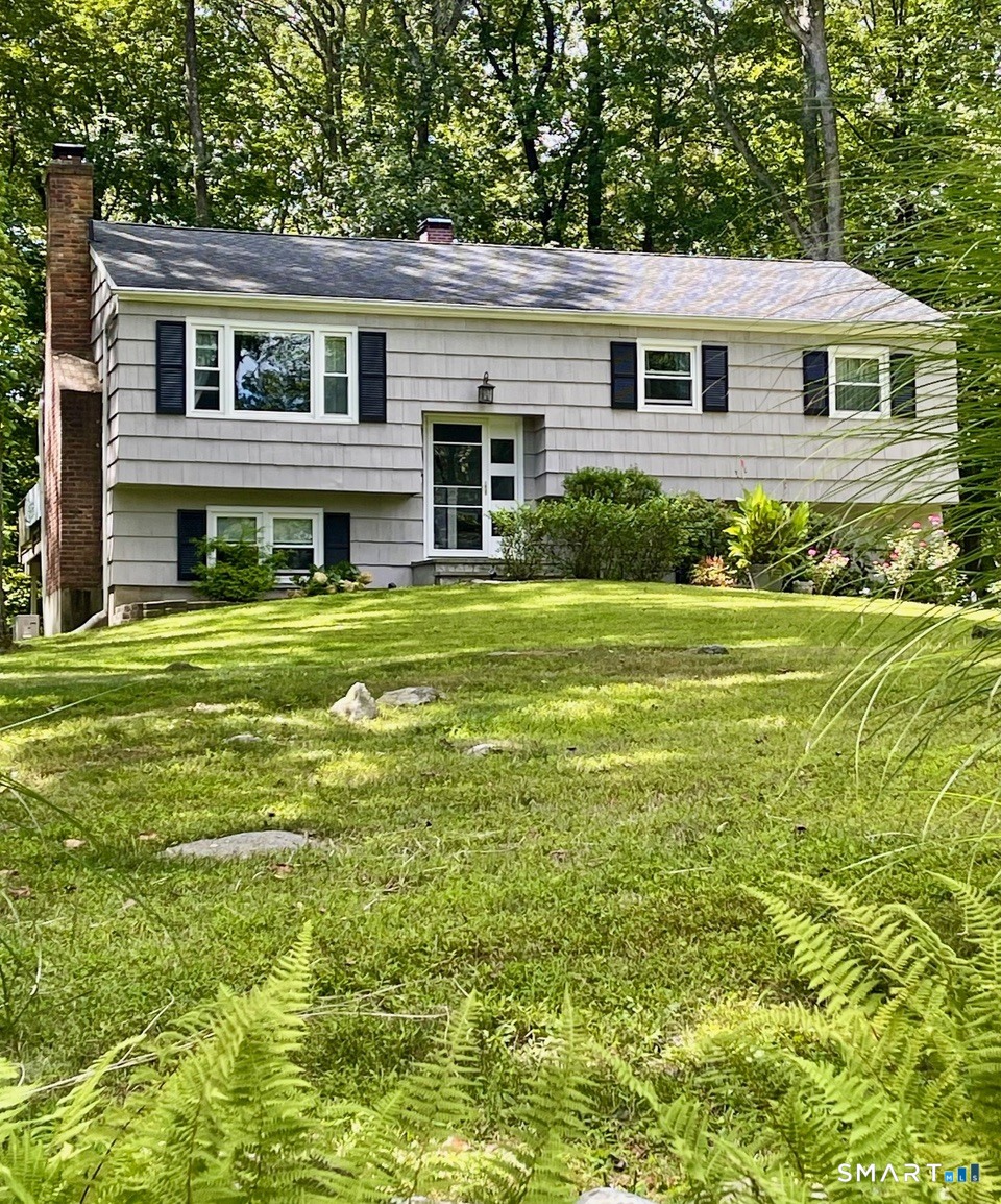 100 Flat Rock Drive Ridgefield, CT 06877 - Photo 3 of 40 a front view of a house with a yard