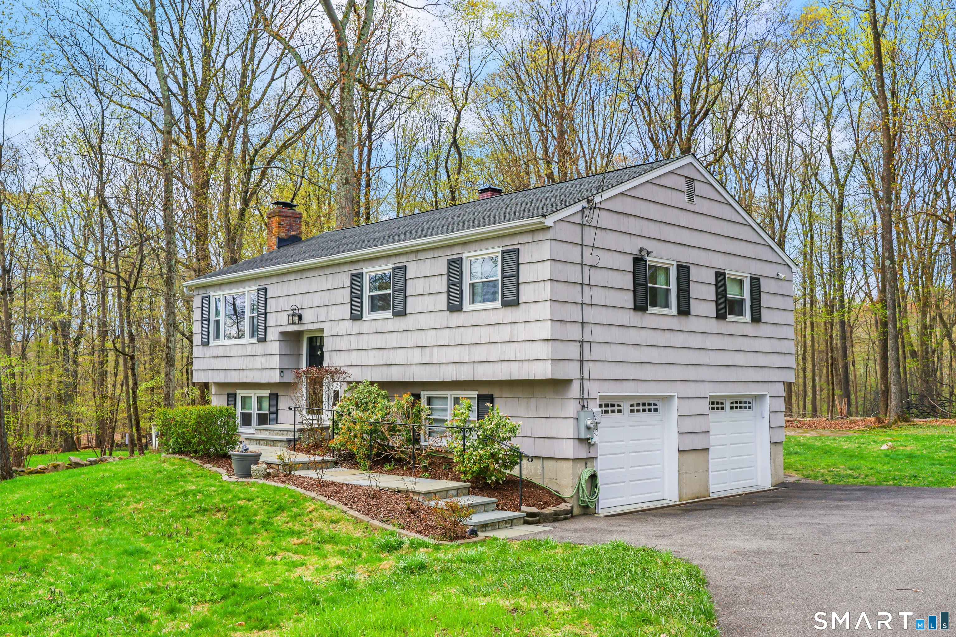 100 Flat Rock Drive Ridgefield, CT 06877 - Photo 37 of 40 a front view of a house with a yard and porch