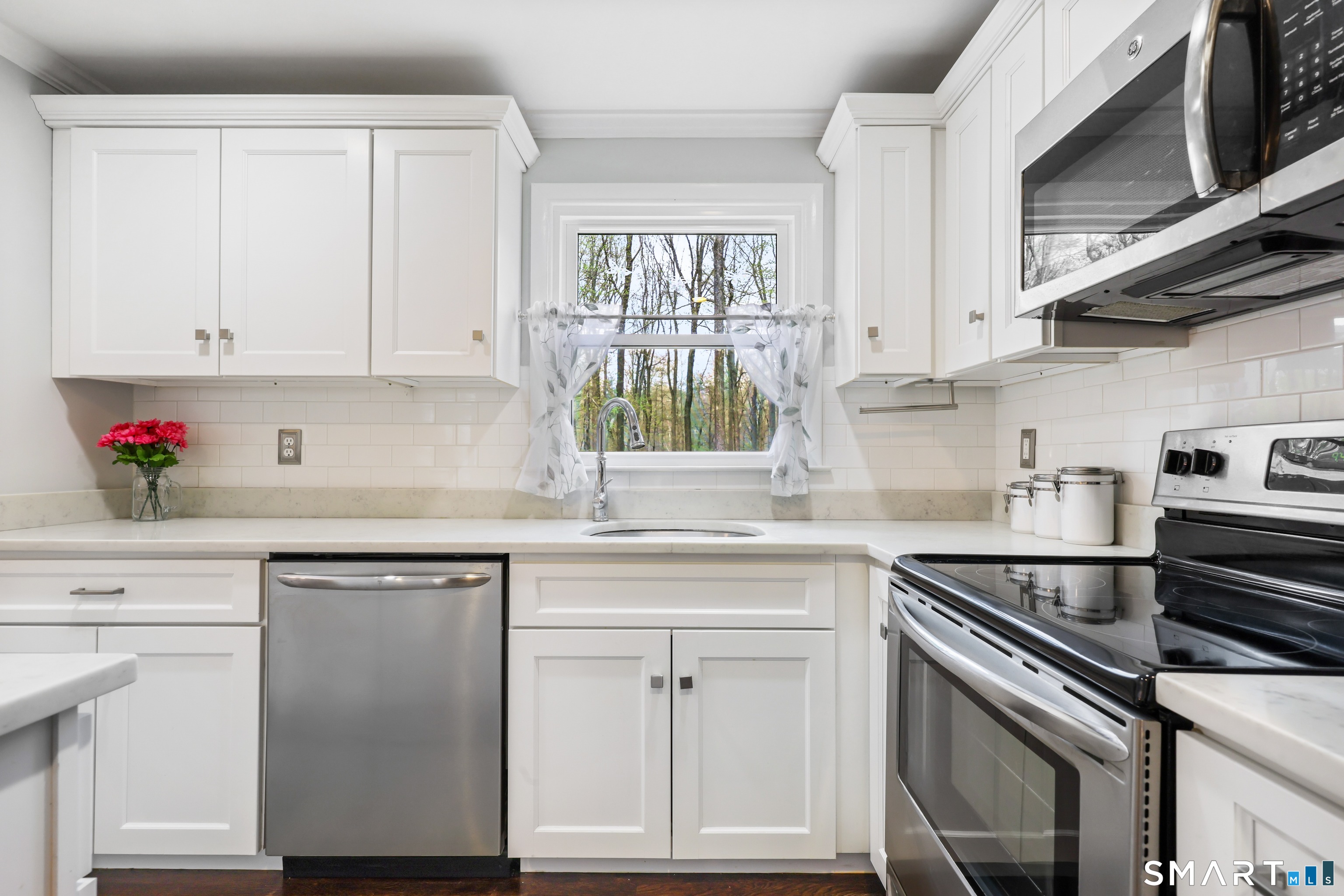 100 Flat Rock Drive Ridgefield, CT 06877 - Photo 6 of 40 a kitchen with cabinets appliances and a window