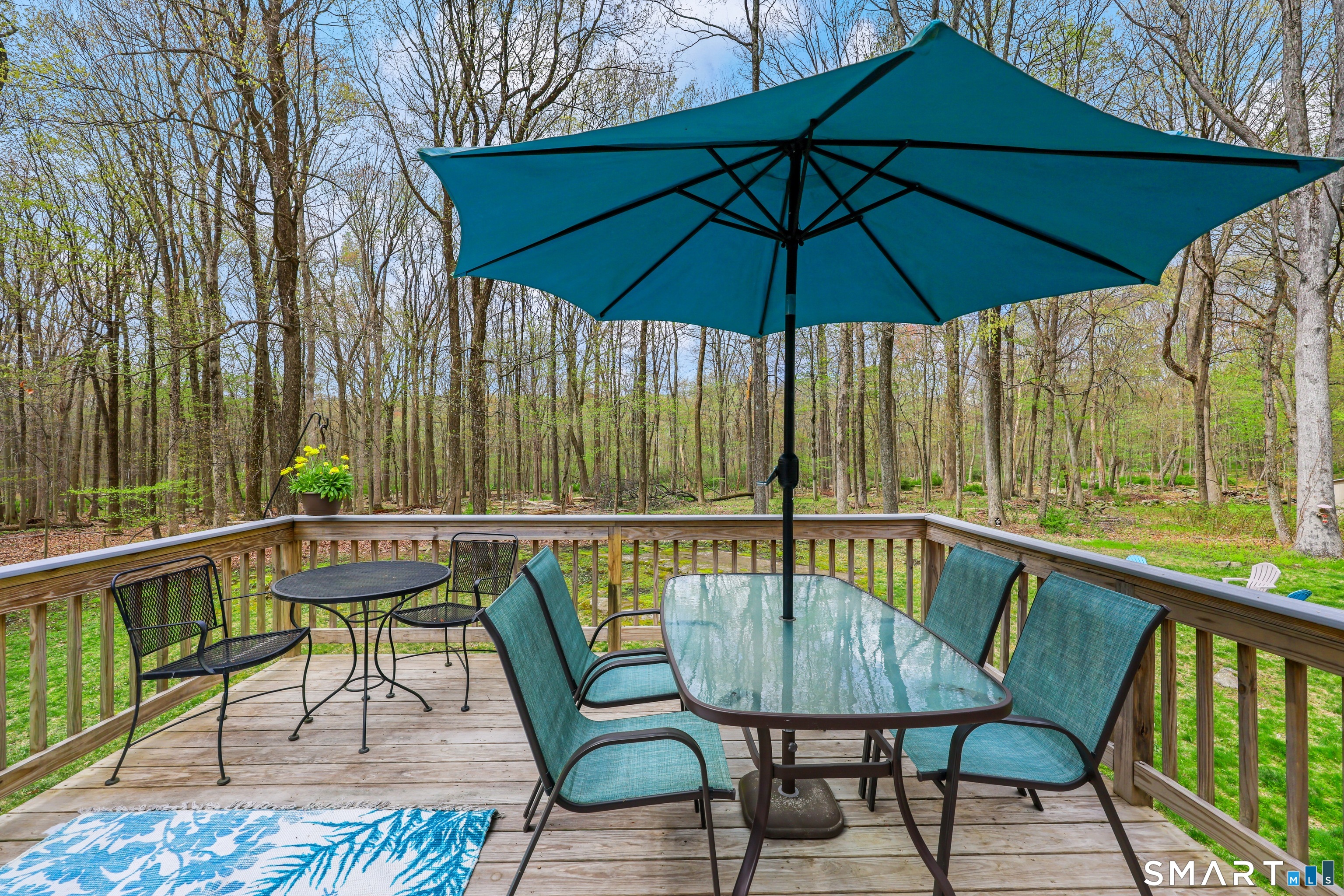 100 Flat Rock Drive Ridgefield, CT 06877 - Photo 8 of 40 a view of sitting area with furniture and umbrella
