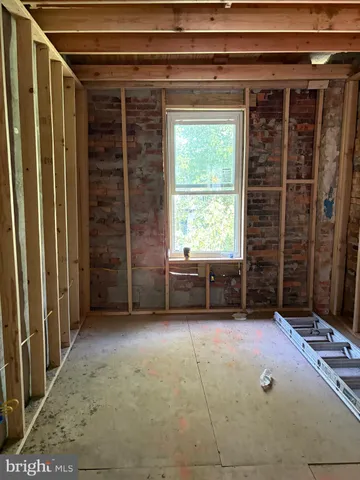 a view of an empty room with a fireplace