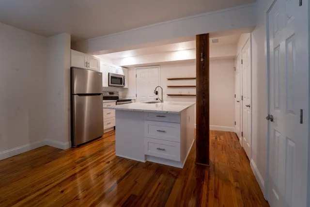 a kitchen with stainless steel appliances a refrigerator and a stove top oven