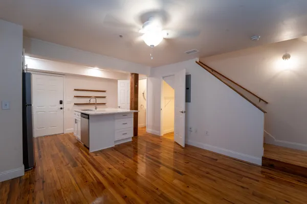 a kitchen with a refrigerator and a stove top oven