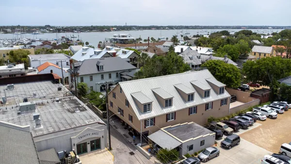 an aerial view of multiple houses with yard