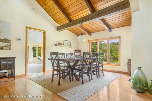 a dining room with furniture and wooden floor