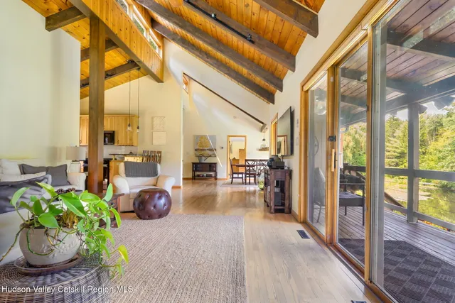a view of a livingroom with furniture and a window
