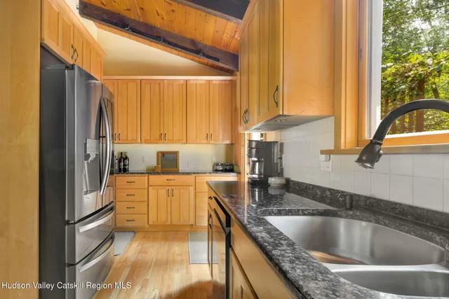 a kitchen with granite countertop a stove and a sink