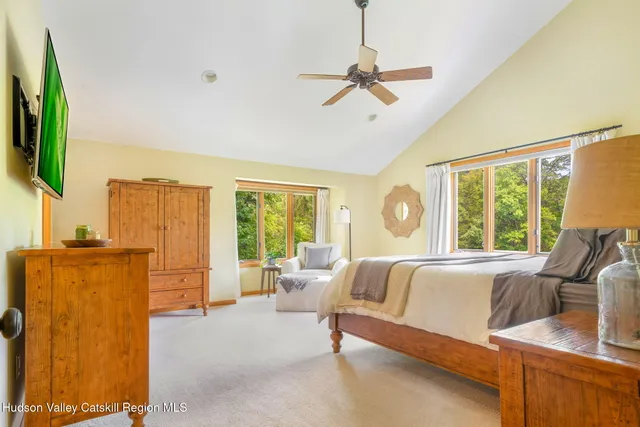 a bedroom with a bed and a large window