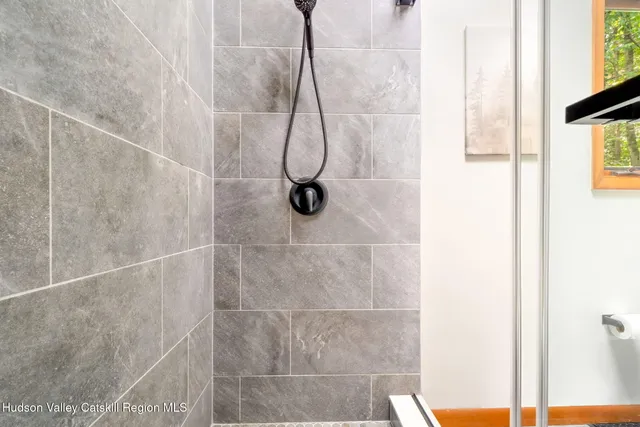 a bedroom with a bed and a mirror