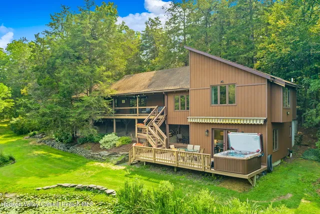 a view of a house with a yard and sitting area