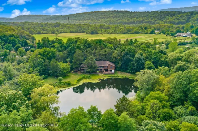 an aerial view of a house with a yard basket ball court and outdoor seating