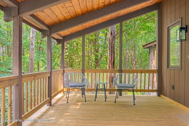 a dining room with furniture entryway wooden floor and a chandelier