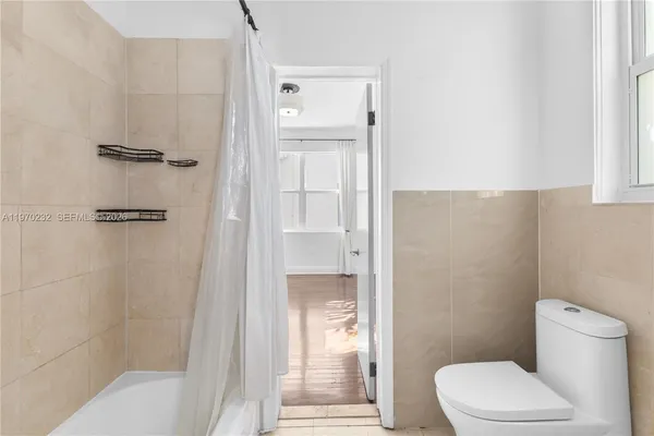 a bathroom with a toilet and a shower