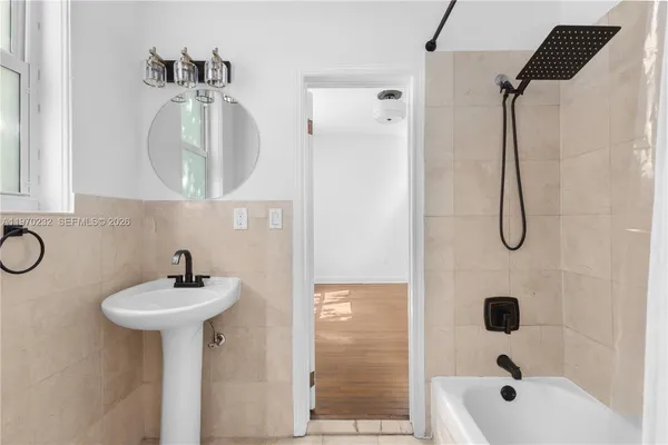 a bathroom with a sink a mirror and shower