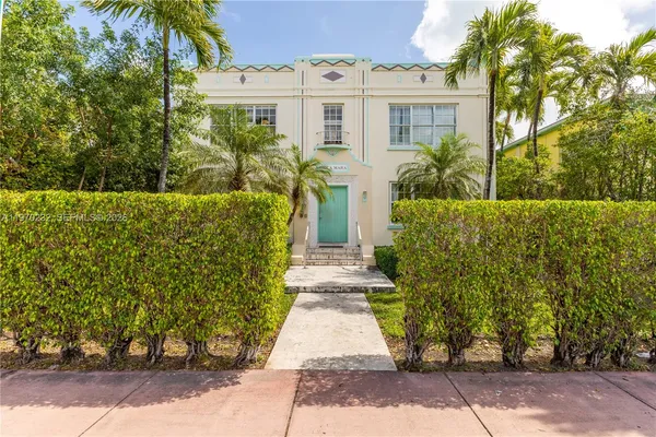a view of a brick house with large windows
