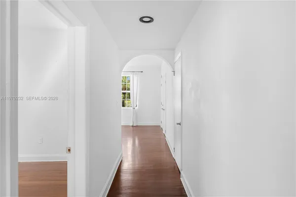 a view of a hallway with wooden floor