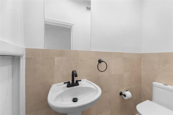 a bathroom with a sink toilet and mirror