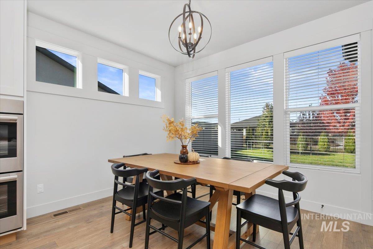 4150 East Fratello Street Meridian, ID 83642 - Photo 17 of 46 Dining room featuring light wood-style floors and a chandelier