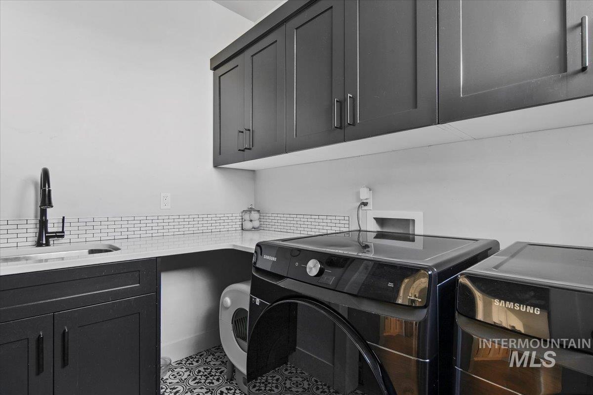 4150 East Fratello Street Meridian, ID 83642 - Photo 21 of 46 Washroom with cabinet space, independent washer and dryer, and tile patterned floors