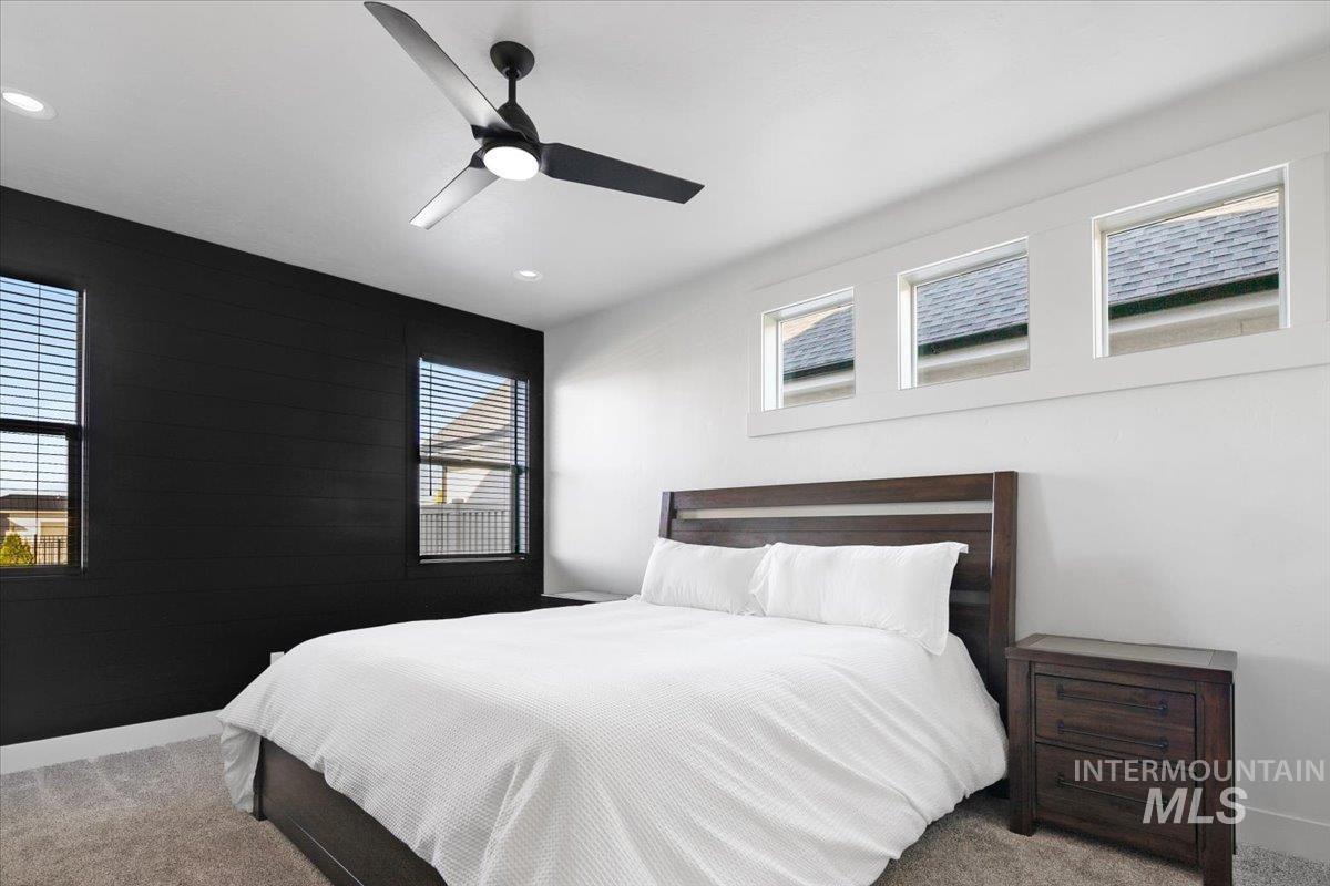 4150 East Fratello Street Meridian, ID 83642 - Photo 22 of 46 Bedroom with carpet flooring, an accent wall, and a ceiling fan
